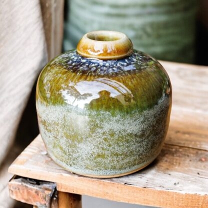 Hand Made Wheel Thrown Small Bottle Vase Decorated In Our Rutile Green Glaze With An Orange Cover 112